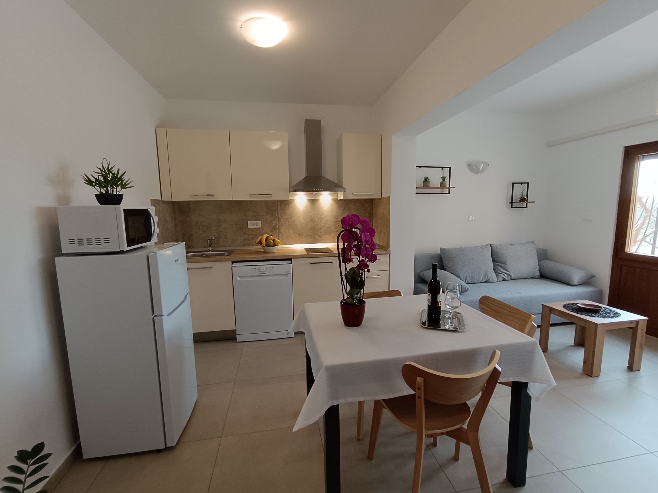 Large bright bedroom with two single beds 90x200. Two night stands near each bed and lamps on them. Beautiful colorful bedsheets and pillows. Painting on the wall. Big window which brings lots of light and chair with mirror next to it.