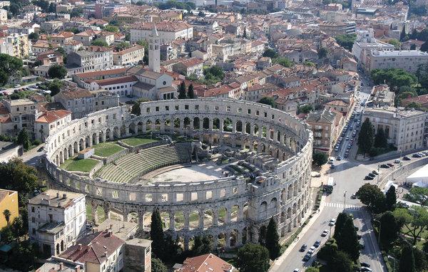 The city center and the Amphiteather, the most famous landmark in the nearby city Pula. Amphiteather with its two-thousand-year old appearance located in the city center. Old and new houses. Beautiful nature around the city.